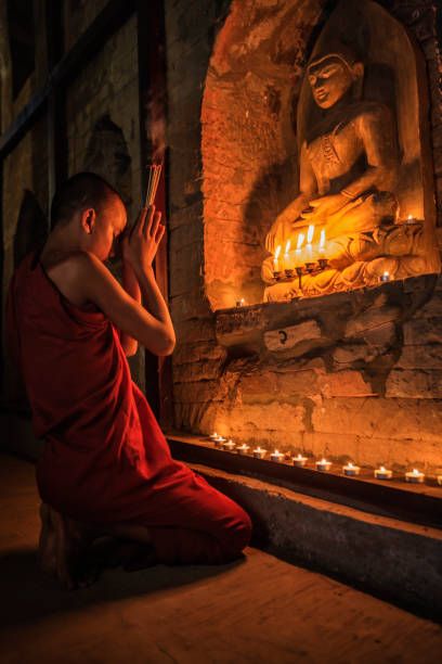 istock Novice buddhist monks contemplating inside temple, Myanmar 1201710670