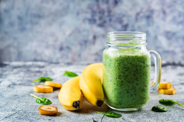 istock Spinach banana smoothies in glass with fresh spinach leaves 1201711857