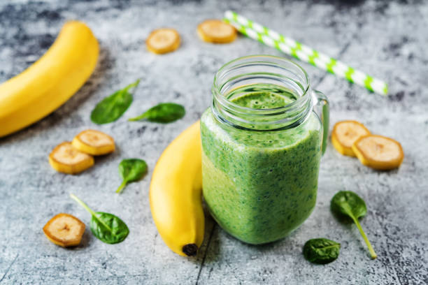 istock Spinach banana smoothies in glass with fresh spinach leaves 1201711865