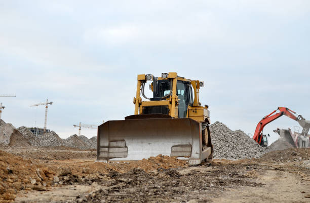 istock Dozer with buckets at construction site. Bulldozer during land clearing, grading, pool excavation, utility trenching and foundation digging. Possible granularity 1201712961