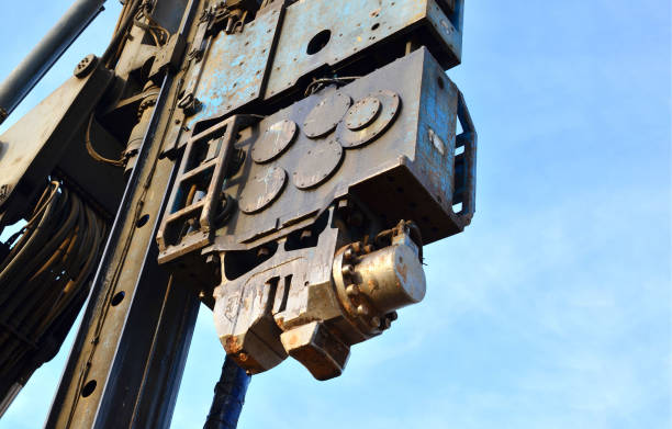 istock Vibrating hydraulic hammer. The hydraulically driven free-fall hammer for impact driving of steel pipes, beams and sheet piles, as well as precast concrete and timber piles. 1201712999
