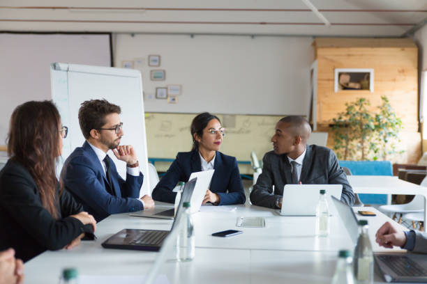 istock Group of thoughtful analysts communicating during meeting 1201713242