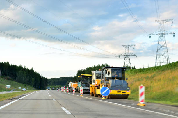 istock Asphalt paver machine working at construction site during asphalt road repair. 1201713249