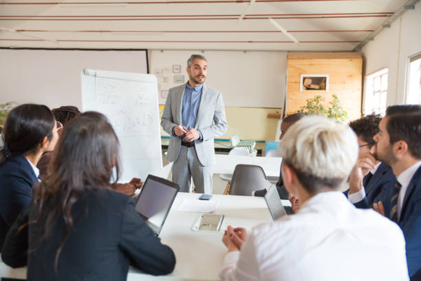 istock Confident speaker talking and looking at colleagues 1201713864