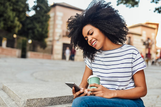istock Beautiful girl using smartphone while waiting for the ride 1201714686