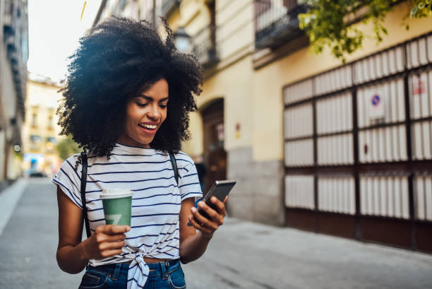 istock Beautiful girl using smartphone while waiting for the ride 1201714689
