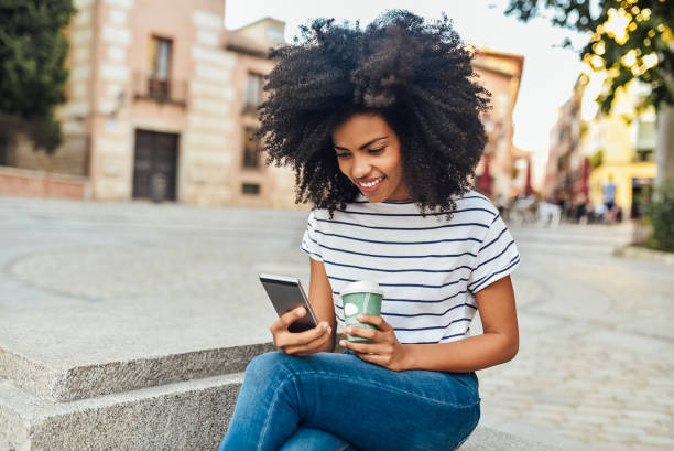 istock Beautiful girl using smartphone while waiting for the ride 1201714690