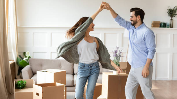 istock Overjoyed couple dance have fun on moving day 1201716207