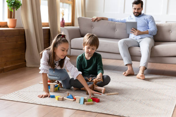istock Happy kids play with bricks spend weekend with dad 1201717118