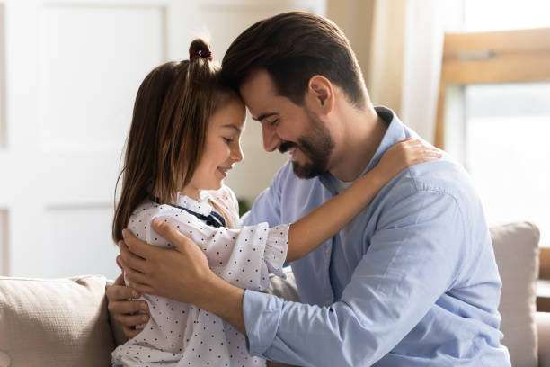istock Loving father and small daughter cuddle sharing close moment 1201717127