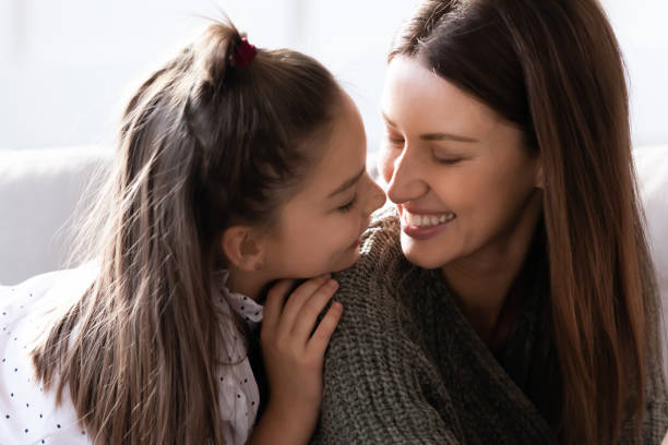istock Smiling mom and little daughter have fun sharing secrets 1201717147