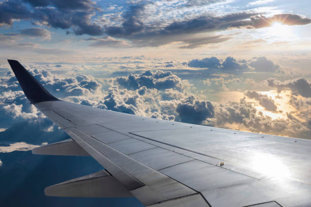 istock Wing of an airplane at sunset 1201717479