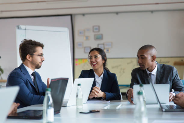 istock Group of cheerful managers communicating during meeting 1201717884