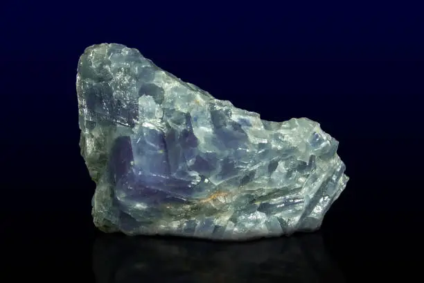 Rock of blue calcite mineral on dark background