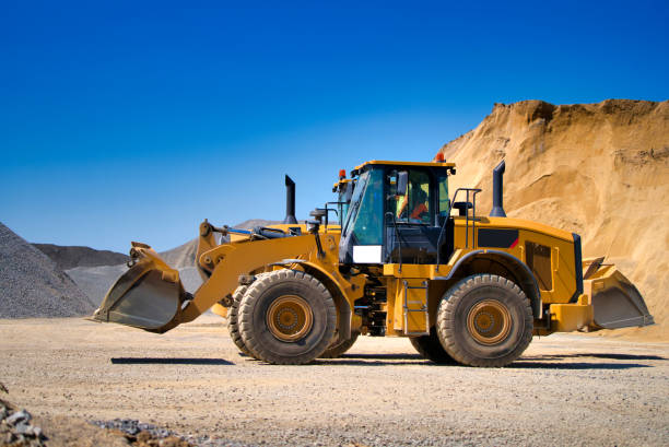 istock Yellow wheel skid-steer loader machine, loading gravel at construction. 1201723974