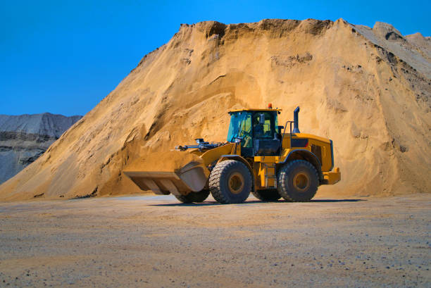 istock Maintenance of yellow excavator on a construction site against blue sky. 1201724048