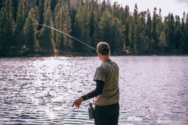 istock Man fishing alone by the lake 1201725192