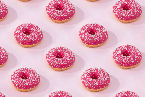istock Pattern of Pink donuts with icing on pink background, flat lay 1201728564