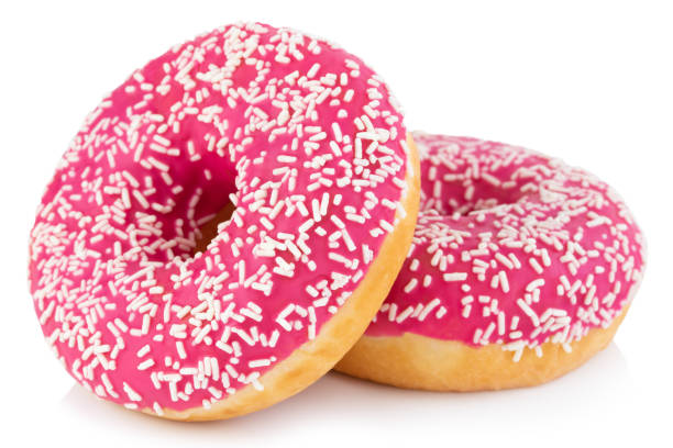 istock Pink donut with colorful sprinkles isolated on white background 1201728572