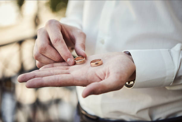 istock man holding wedding rings, groom getting ready in the morning before ceremony 1201728748