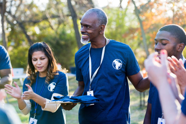 istock Group applauds when coordinator acknowledges contribution by young volunteer 1201729925