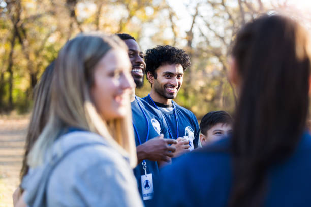 istock Diverse volunteers enjoy talking and laughing together 1201729931