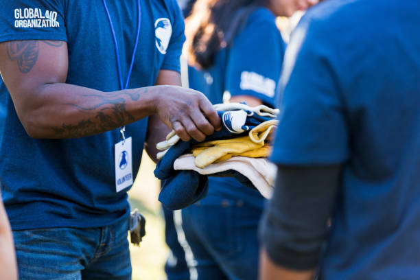 istock Unrecognizable man hands out safety gloves at cleanup event 1201729946