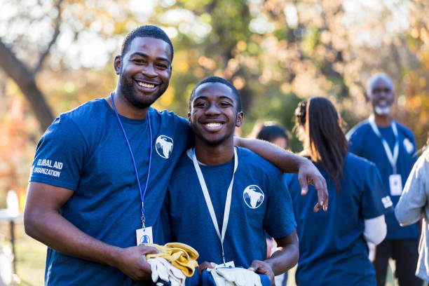 istock Father and son pose for photo before park cleanup begins 1201729947