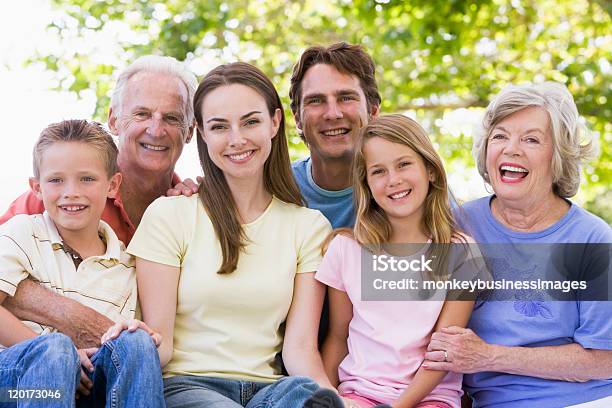 Threegeneration Family Smiling At The Park Together Stock Photo - Download Image Now