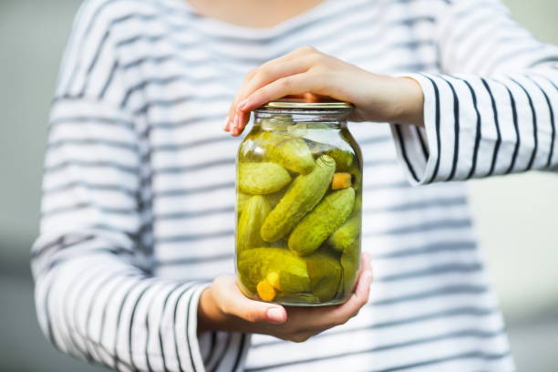 istock hands hold a can of marinated cucumbers 1201738768