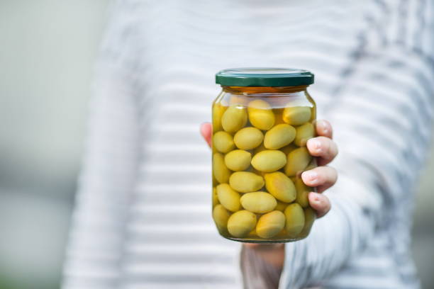 istock hand hold a can of marinated olives 1201738773