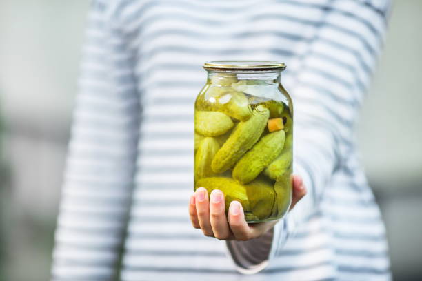 istock hand hold a can of marinated cucumbers 1201738774