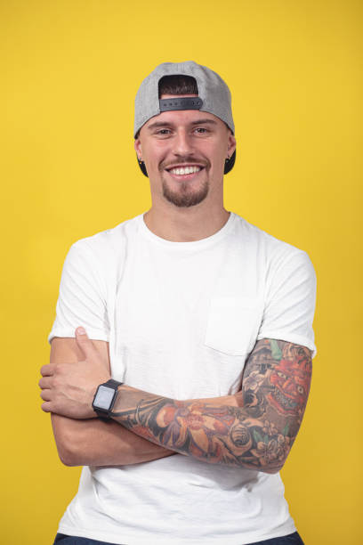 istock Beautiful young man with a colorful sleeve tattoo 1201746076
