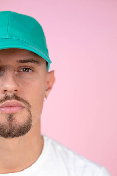 istock Headshot of a man wearing a turquoise cap hat 1201746105