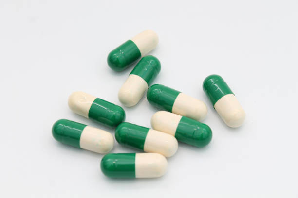 Green and white capsules isolated on white background