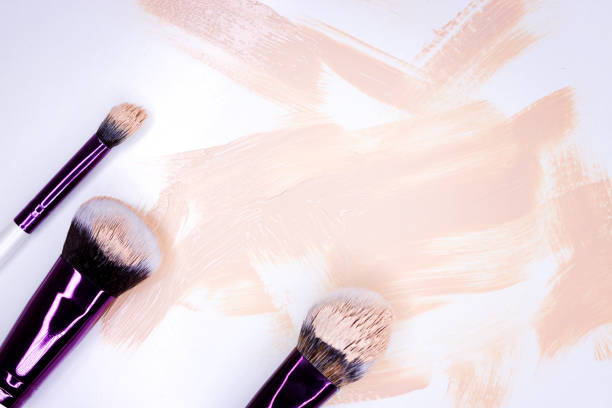 istock Makeup brush on a light background with a tonal foundation 1201749177
