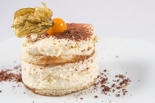 A modern dessert of creamy Tiramisu with physalis.