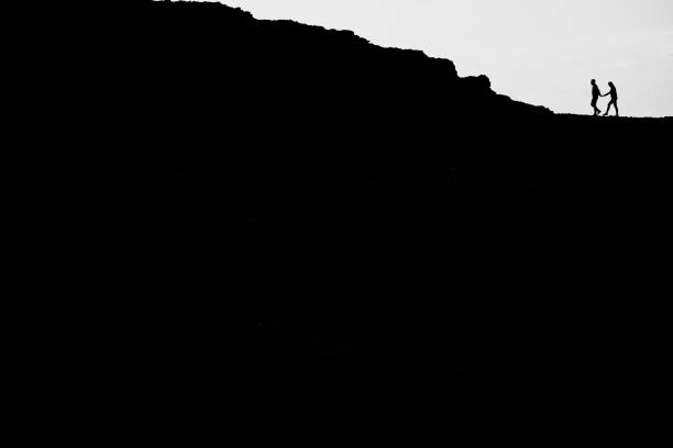 istock Silhouette of a couple on a mountain 1201751738