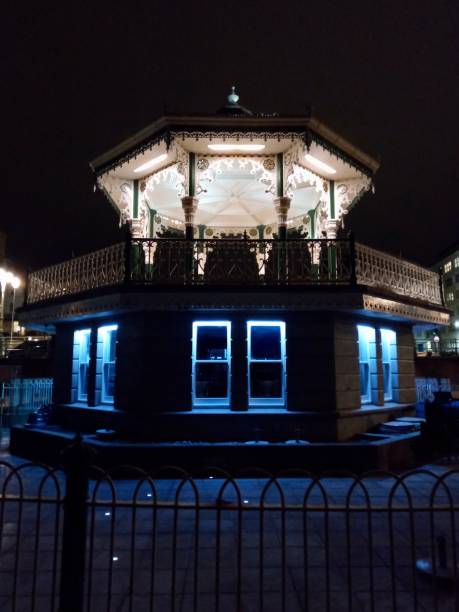 istock Brighton Bandstand at night with urban skyline in UK 1201752789