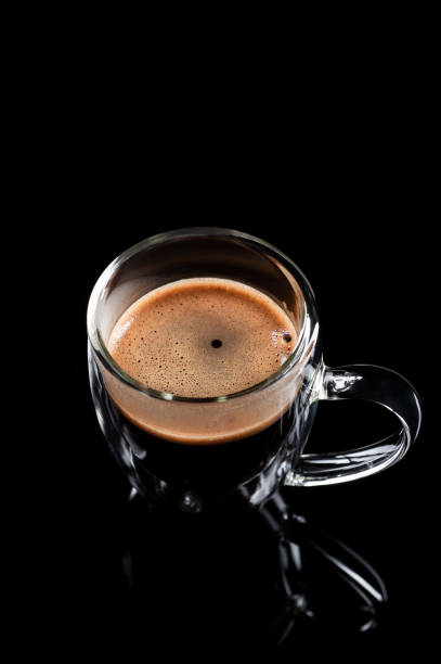 istock black coffee in a glass transparent cup on a black background 1201754710