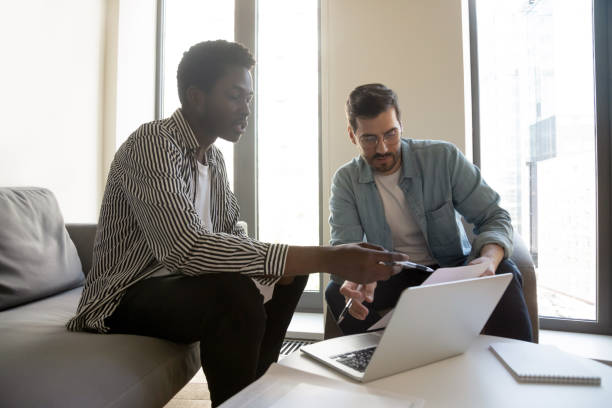 istock African caucasian entrepreneurs sitting in modern office solving common issues 1201756522