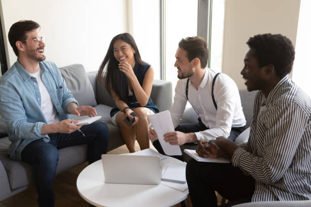 istock Cheerful diverse colleagues discuss working moments in friendly informal atmosphere 1201756551