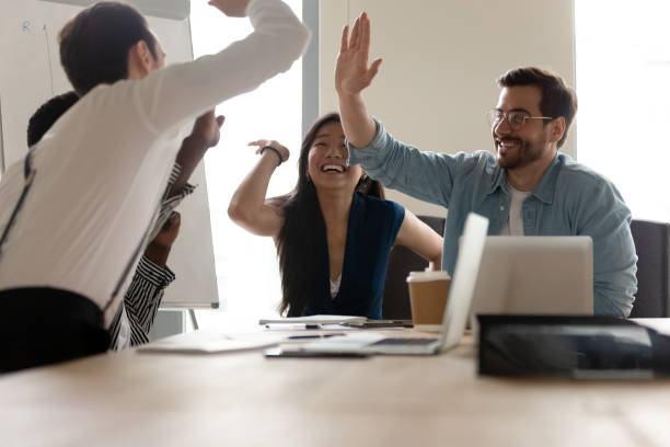 istock Multi-ethnic businesspeople giving high five celebrating closing profitable deal 1201756571