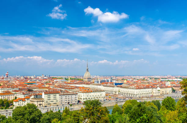 Aerial top panoramic view of Turin city center skyline with Piazza Vittorio Veneto square, Po river and Mole Antonelliana building with high spire, blue sky white clouds background, Piedmont, Italy stock photo