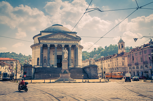 Bike and trams ride on square piazza in front of Catholic Parish Church Chiesa Gran Madre Di Dio neoclassic style building and Vittorio Emanuele monument, historical centre Turin city, Piedmont, Italy