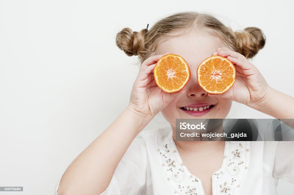 Juicy mandarin fruits Little girl having fun with fresh mandarins Cheerful Stock Photo