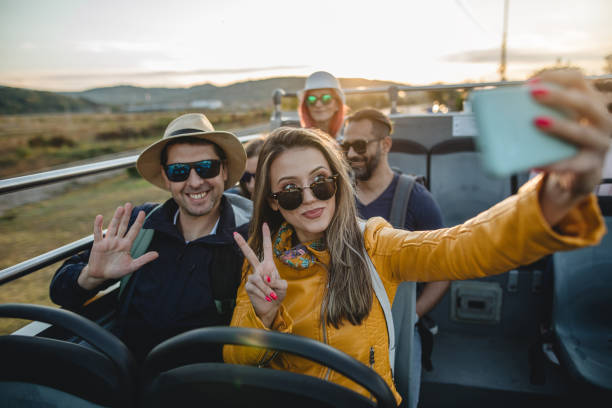 istock Cute couple having fun while enjoying a ride on a tour bus 1201757860
