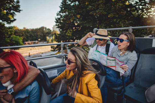 istock Cheerful group of tourists having fun on a open-air bus 1201757986