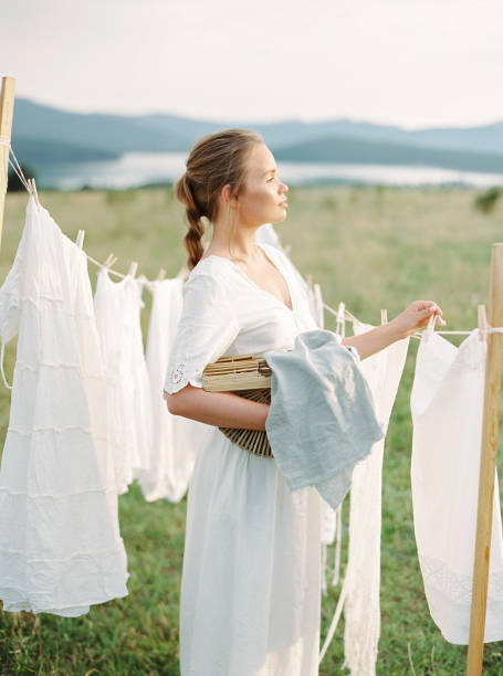 istock Woman Hanging white clothes Out To Laundry 1201760629