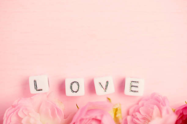 istock Pink roses with love word alphabet 1201761819